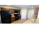 Well-equipped kitchen featuring dark appliances, ample storage, and convenient access to the dining and living areas at 5045 Bayberry Crest St, North Las Vegas, NV 89031