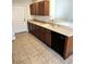 Traditional kitchen with wood cabinets, neutral countertops, modern appliances and durable tile flooring at 5045 Bayberry Crest St, North Las Vegas, NV 89031