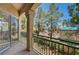 This balcony features a textured post, green metal railing, and street views with mature trees at 5155 W Tropicana Ave # 2095, Las Vegas, NV 89103