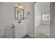 Bathroom with bronze fixtures, mirrors, and vanity with cabinet at 5155 W Tropicana Ave # 2095, Las Vegas, NV 89103