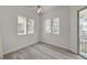 Bedroom featuring a ceiling fan, two windows, and a sliding glass door to a balcony at 5155 W Tropicana Ave # 2095, Las Vegas, NV 89103