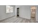 Bedroom with new gray flooring, and bright natural light coming through the window, walk-in closet, and bathroom at 5155 W Tropicana Ave # 2095, Las Vegas, NV 89103