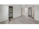 Large bedroom with new gray flooring, open closet, and doorways to other rooms at 5155 W Tropicana Ave # 2095, Las Vegas, NV 89103