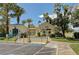 Exterior view of the community clubhouse, lush landscaping, and ample parking at 5155 W Tropicana Ave # 2095, Las Vegas, NV 89103