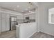 Kitchen featuring modern lighting, gray cabinets, stainless steel appliances, and a breakfast bar at 5155 W Tropicana Ave # 2095, Las Vegas, NV 89103