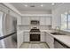Kitchen featuring gray cabinets, quartz countertops, stainless steel appliances, and tiled backsplash at 5155 W Tropicana Ave # 2095, Las Vegas, NV 89103