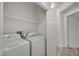 Bright laundry room with white washer, dryer, and shelving for storage at 5155 W Tropicana Ave # 2095, Las Vegas, NV 89103