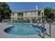 Sparkling community pool and surrounding building with balconies and well-kept grounds at 5155 W Tropicana Ave # 2095, Las Vegas, NV 89103