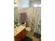 Functional bathroom featuring a vanity with sink, toilet, and shower with decorative curtain at 5216 Loma Verde Ave, Las Vegas, NV 89108