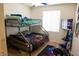 Vibrant bedroom featuring a unique bunk bed setup and a modern gaming station at 5216 Loma Verde Ave, Las Vegas, NV 89108