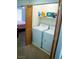 Convenient laundry room featuring a washer, dryer, and extra storage space at 5216 Loma Verde Ave, Las Vegas, NV 89108