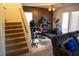 Inviting living room with stairs and a cozy gray sofa, filled with fitness equipment at 5216 Loma Verde Ave, Las Vegas, NV 89108