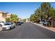 Neighborhood street with multiple parked cars, trees, and residential homes at 5216 Loma Verde Ave, Las Vegas, NV 89108