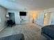 This bedroom features a mounted television, minimalist furnishings, and a view of an en-suite bathroom at 5474 S Maryland Pkwy, Las Vegas, NV 89119
