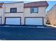 Townhome with white garage doors, a red tile roof and a stucco exterior at 5474 S Maryland Pkwy, Las Vegas, NV 89119