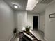 Well-lit hallway with skylight, decorative planters, and access to multiple rooms offers a welcoming transition at 5474 S Maryland Pkwy, Las Vegas, NV 89119