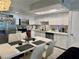 Bright eat-in kitchen featuring white cabinets, stainless steel appliances and modern finishes at 5474 S Maryland Pkwy, Las Vegas, NV 89119