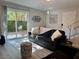 Living room with sliding glass door leading to a patio, comfortable sofa, and natural light at 5474 S Maryland Pkwy, Las Vegas, NV 89119