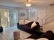 Cozy living room with light-colored floors, comfortable sofa, and a ceiling fan at 5474 S Maryland Pkwy, Las Vegas, NV 89119