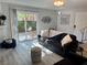 Living room with sliding glass door leading to a patio, comfortable sofa, and modern decor at 5474 S Maryland Pkwy, Las Vegas, NV 89119