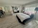 Bright main bedroom featuring a large window, comfortable bed, and ample closet space at 5474 S Maryland Pkwy, Las Vegas, NV 89119