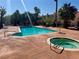Relaxing community pool and spa area surrounded by mature palm trees and lush landscaping at 5474 S Maryland Pkwy, Las Vegas, NV 89119