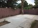 Spacious backyard featuring a patio area with a tall palm tree and a wood fence at 5615 Blue Sea St, Las Vegas, NV 89110