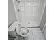 Bright bathroom featuring a toilet with an elongated bowl and a shower with white wall panels at 5615 Blue Sea St, Las Vegas, NV 89110