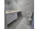Bright bathroom with tile floors and a modern vanity offers functionality at 5615 Blue Sea St, Las Vegas, NV 89110