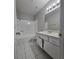 Clean bathroom with white tile flooring, tub-shower combo, and sleek vanity at 5615 Blue Sea St, Las Vegas, NV 89110