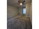Bedroom features neutral walls, carpeting, and ceiling fan at 5615 Blue Sea St, Las Vegas, NV 89110