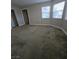 Spacious bedroom featuring neutral walls, plush carpeting, and two bright windows at 5615 Blue Sea St, Las Vegas, NV 89110