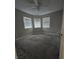 Bedroom with three large windows and neutral carpet at 5615 Blue Sea St, Las Vegas, NV 89110