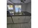 Kitchen island featuring white cabinets and a stainless steel sink at 5615 Blue Sea St, Las Vegas, NV 89110