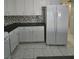 Traditional kitchen featuring white cabinets, stainless appliances, and tile backsplash at 5615 Blue Sea St, Las Vegas, NV 89110