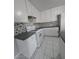 Bright kitchen boasts white cabinets, modern appliances, and a sleek gray countertop at 5615 Blue Sea St, Las Vegas, NV 89110