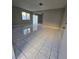 Bright living room with ceramic tile flooring and abundant natural light at 5615 Blue Sea St, Las Vegas, NV 89110