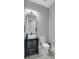 Modern bathroom featuring a vanity with a black cabinet, a unique sink, and a toilet at 5812 Shangri La Night Ct, Las Vegas, NV 89149