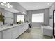 Spacious bathroom featuring dual vanities, soaking tub, and bright, neutral tones at 5812 Shangri La Night Ct, Las Vegas, NV 89149