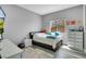 Cozy bedroom with natural light, featuring a bed, dresser, and contemporary decor at 5812 Shangri La Night Ct, Las Vegas, NV 89149