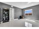Empty room with neutral walls, tile flooring, a window, and a bookshelf, showcasing versatile space at 5812 Shangri La Night Ct, Las Vegas, NV 89149