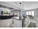 Spacious kitchen with an island, stainless steel appliances, and an open floor plan into the living area at 5812 Shangri La Night Ct, Las Vegas, NV 89149