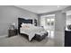 Spacious main bedroom featuring lots of tile, a bed with a decorative headboard, and contemporary decor at 5812 Shangri La Night Ct, Las Vegas, NV 89149