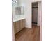 Neutral bathroom vanity with a sink and large mirror, and walk-in shower at 6470 Shining Sand Ave, Las Vegas, NV 89142