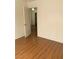 The bedroom features durable laminate flooring, a closet, and neutral walls at 6470 Shining Sand Ave, Las Vegas, NV 89142