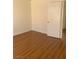 Bedroom with laminate flooring, a white door, and neutral-colored walls at 6470 Shining Sand Ave, Las Vegas, NV 89142