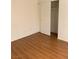 Bright bedroom features laminate flooring and a sliding-door closet at 6470 Shining Sand Ave, Las Vegas, NV 89142