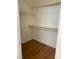 Walk-in closet features hardwood floors and adjustable shelving at 6470 Shining Sand Ave, Las Vegas, NV 89142
