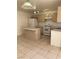 Functional kitchen featuring tile floors, standard appliances, and ample cabinet space at 6470 Shining Sand Ave, Las Vegas, NV 89142