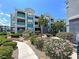 Attractive apartment building exterior with lush landscaping and a well-maintained walkway at 6955 N Durango Dr # 1022, Las Vegas, NV 89149